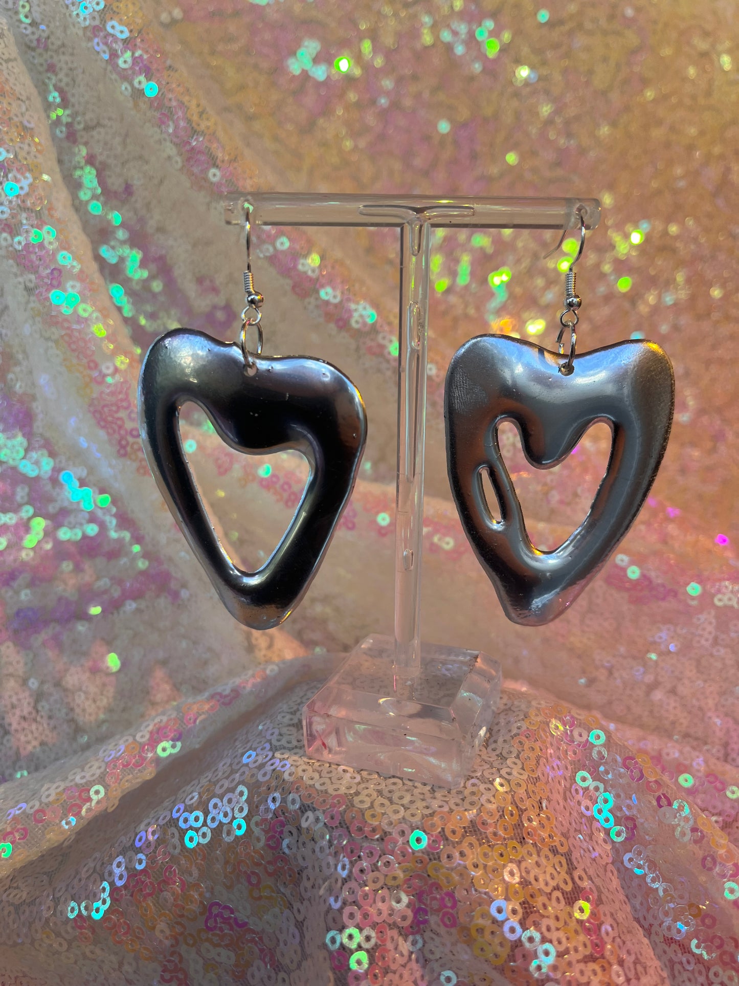 Metallic silver heart earrings.