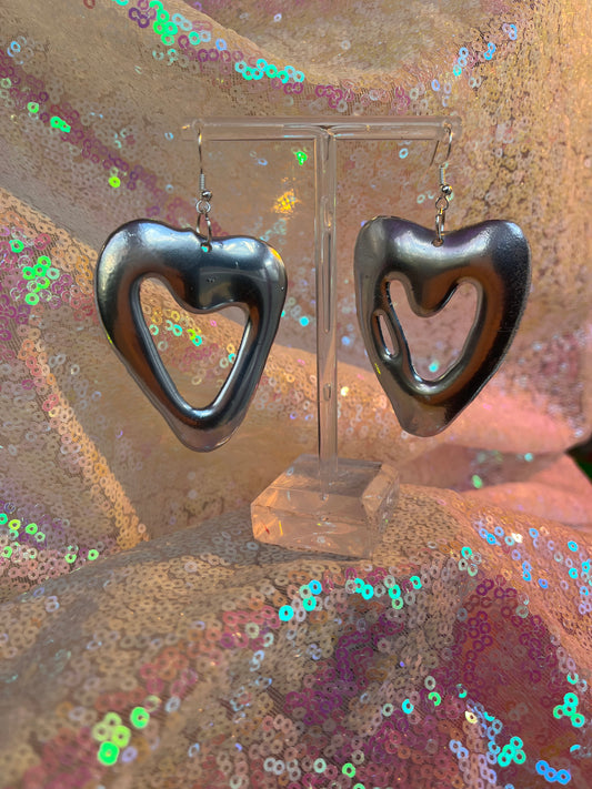 Metallic silver heart earrings.